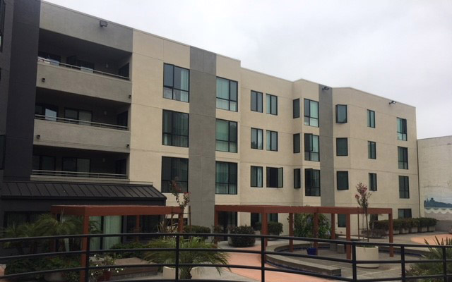 The exterior of the apartment building from the courtyard.